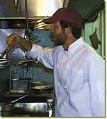 Chef preparing Asian fusion dishes in the kitchen